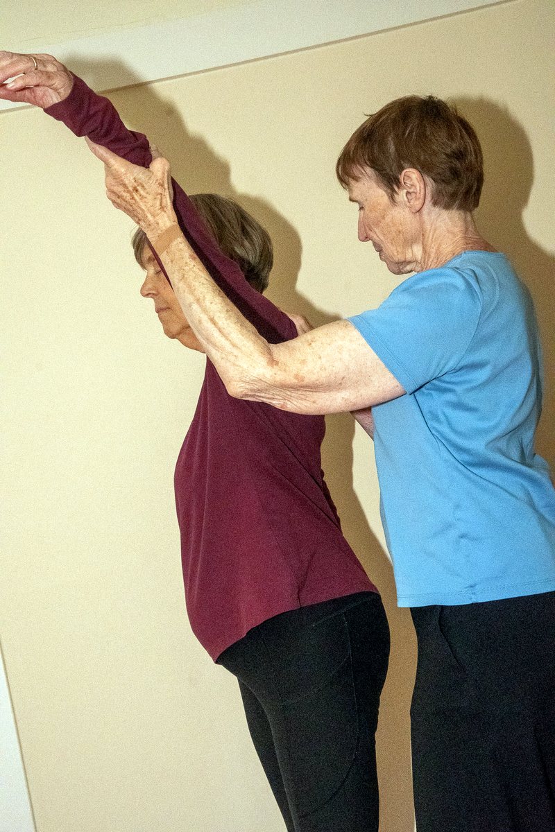 Guided reach up the wall, lengthening the whole back line