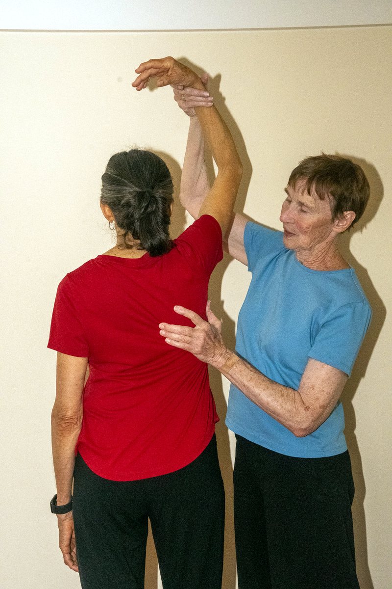 Guiding a reach — the arm lengthening upward with ease